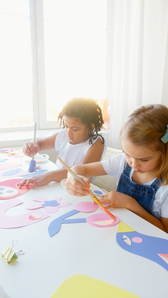 Children enjoying painting art projects with bright colors indoors.